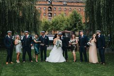 a group of people standing next to each other on top of a lush green field