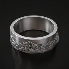 Celebrate your love for the great outdoors with this beautifully crafted Mountain Range Wedding Band in 925 Sterling Silver. Featuring an intricate landscape design of majestic mountain peaks, this ring is perfect for nature lovers, hikers, or anyone with a passion for adventure. Its durable silver construction ensures lasting quality, making it a great choice for daily wear or special occasions. The unique design symbolizes the strength and beauty of nature, making it a meaningful piece for weddings, anniversaries, or as a thoughtful gift for your adventurous partner. Available in various sizes to ensure the perfect fit, this ring captures the essence of the wilderness and the spirit of exploration. ⚜️ Package included: Unisex Silver Ring - Made to order ⚜️ Sizes: From 3 to 15 US ⚜️ Mater Viking Ring, Masonic Ring, Retro Ring, Animal Rings, Cross Ring, Everyday Rings, Handmade Rings, Gifts For Brother, Ring Unique