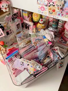 a suitcase filled with lots of toys and other stuff items on top of a table