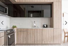 a kitchen with wooden cabinets and stainless steel appliances