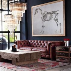 a living room filled with furniture and a horse drawing on the wall