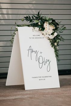 a wedding sign with flowers on it