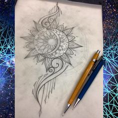 a pen is sitting on top of a paper with an intricate design in the middle