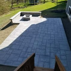 an outdoor patio with benches and fire pit