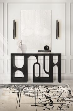 a black and white area rug with an abstract design on the floor in front of it