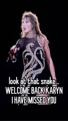 a woman in a black dress holding a microphone with the words, look at that snake welcome back karyn i have missed you