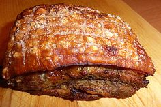 a meatloaf sitting on top of a wooden cutting board