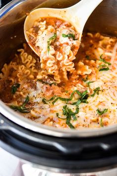 a ladle full of pasta and meat in an instant pot