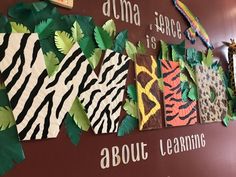 there is a sign that says about learning with paper animals and leaves on the wall