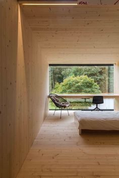 a bedroom with wooden walls and flooring