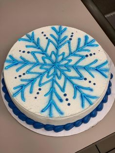 a white cake with blue frosting on top