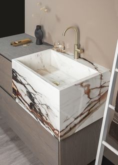 a white sink sitting on top of a wooden counter