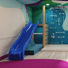 a kids's playroom with a slide and climbing wall in the background,