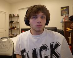 a young man wearing headphones in his living room