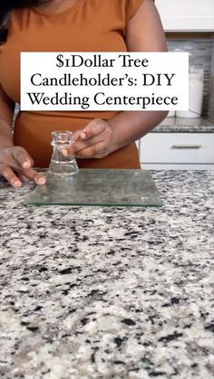 a woman standing at a counter holding a glass with the words $ dollar tree candleholder's diy wedding centerpiece