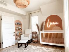 a baby's room decorated in pink and white