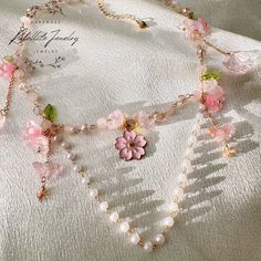 Adorn yourself with the magic of springtime with our Sakura Necklace, featuring a delicate cherry blossom charm at its center, surrounded by intricate glass flowers and butterflies. Inspired by the beauty of spring, this necklace exudes a dreamy pink cherry blossom vibe, reminiscent of fairy blossoms in full bloom. 🌸 Spring Pink Cherry Blossom Vibe: Indulge in the beauty of spring with this necklace, which radiates a soft pink cherry blossom vibe. Whether you're attending a garden party, a spri Sakura Necklace, Pink Flower Necklace, Cherry Blossom Necklace, Necklace Fairy, Fairy Necklace, Basic Jewelry, Pink Cherry, Pink Necklace, Glass Flowers