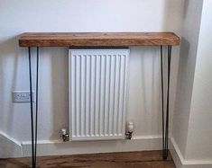 a radiator and some hair pins are on the floor in front of a white wall