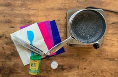 a frying pan with two tongs on top of it next to a napkin