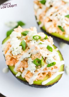 a white bowl filled with cucumbers and other food on top of a table