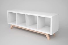 a white bookcase with three shelves on one side and two open ones on the other