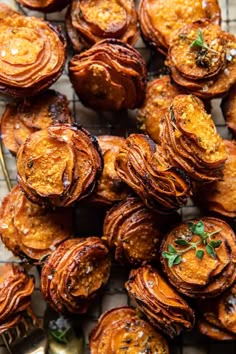 baked sweet potatoes on a cooling rack with a fork and spoon next to them, ready to be eaten