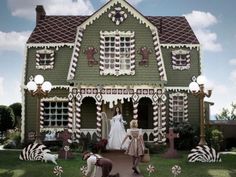 two people standing in front of a house decorated with candy canes