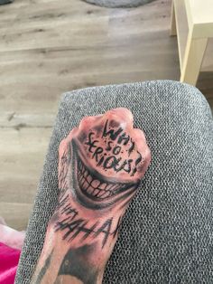 a person with a tattoo on their arm has a fist in the shape of a mouth