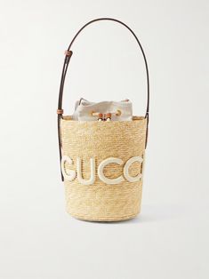 GUCCI Leather-trimmed appliquéd raffia bucket bag | NET-A-PORTER Gucci Bucket Bag, A 3d Logo, Raffia Bucket Bag, Bucket Bags, Raffia Bag, Gucci Leather, Summer 24, 3d Logo, Manado