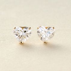 Add some dazzling romance to your style with these lovely 1.00 or 2.00 carat heart-shape lab-grown diamond stud earrings from Peace Jewelers. You'll love the gorgeous sparkle on your lobes! The pair is finely crafted in your choice of rich 14K yellow or white gold with a brilliant polished finish. They safely secure with butterfly backs. Pair them with matching necklace 215-187 to create a stunning coordinated style. Diamond Stud Earrings, Diamond Stud, Matching Necklaces, 2 Carat, Diamond Earrings Studs, Heart Shape, Lab Grown, Lab Grown Diamonds, Diamond Earrings