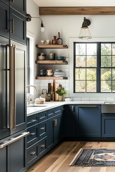 a kitchen with dark blue cabinets and wooden floors is pictured in this image from the front view