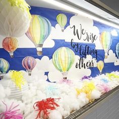 there are many hot air balloons in the sky on this bulletin board that says we rise