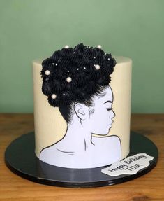 a black and white cake with a woman's face on it