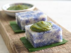 two pieces of soap sitting on top of a wooden cutting board