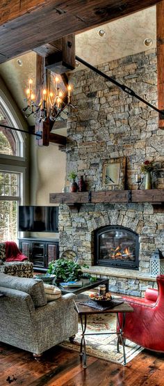 a living room filled with lots of furniture and a fire place in the middle of it