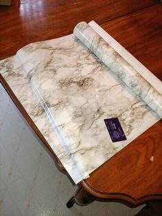 a marble table top with a roll of paper on it