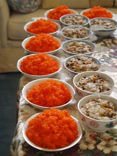 there are many small bowls with food in them on the table next to each other