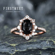 a ring with a black diamond surrounded by white diamonds