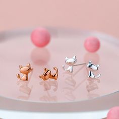 These tiny cat silhouette stud earrings from The Silver Luna make it easy and effortless to bring a feline friend by your side all day long. Crafted from high polish sterling silver, the simple yet delightful cat shape design adds a subtle, sweet touch to any outfit. Whether you're an avid cat lover, or know someone who is, these cat stud earrings offer a fun and fashionable way to pay homage to our purrfect companions, without all the hair and fur. Perfect for everyday wear, they're ideal for c Cat Stud Earrings, Tiny Cats, Cat Earrings Studs, Cat Silhouette, Animal Earrings, Silver Coat, Earring Crafts, Moonstone Jewelry, Rose Gold Earrings