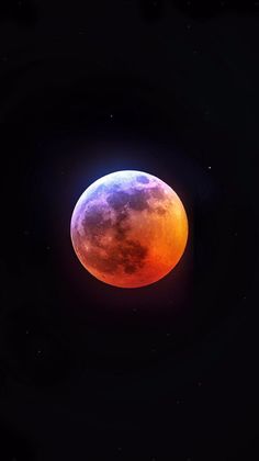 an orange and blue moon in the dark sky