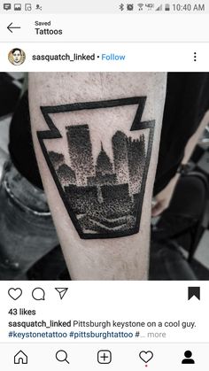 a man's arm with a black and white cityscape tattoo on it