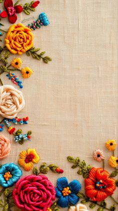 colorful flowers are arranged in the shape of a frame on a linen background with space for text