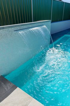 a blue pool with water flowing from it