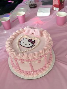 a hello kitty birthday cake on a table