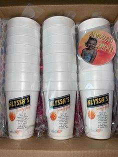 three plastic cups are sitting in a box