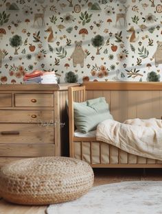 a bedroom with a bed, dresser and wallpaper in the background that has deers on it