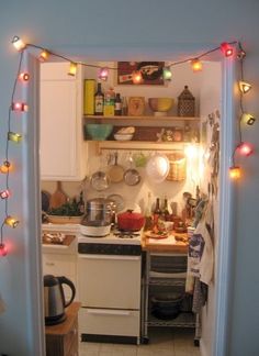 the kitchen is decorated with christmas lights and dishes