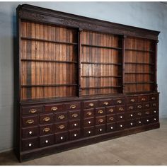 an old wooden bookcase with many drawers