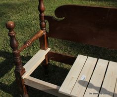 a wooden bench sitting on top of a lush green field