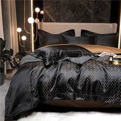 a black and gold bedroom with lights on the headboard